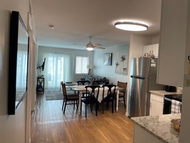 dining space featuring ceiling fan and light hardwood / wood-style floors