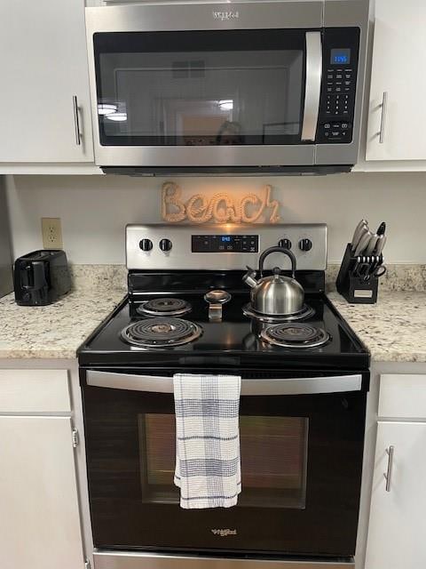 kitchen featuring appliances with stainless steel finishes and white cabinetry