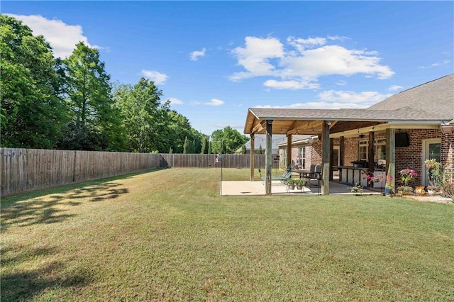 view of yard with a patio, a fenced backyard, and ceiling fan