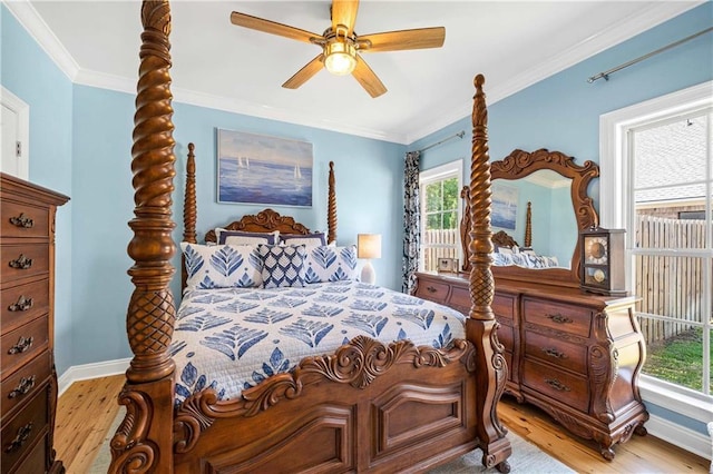 bedroom featuring a ceiling fan, baseboards, ornamental molding, and wood finished floors