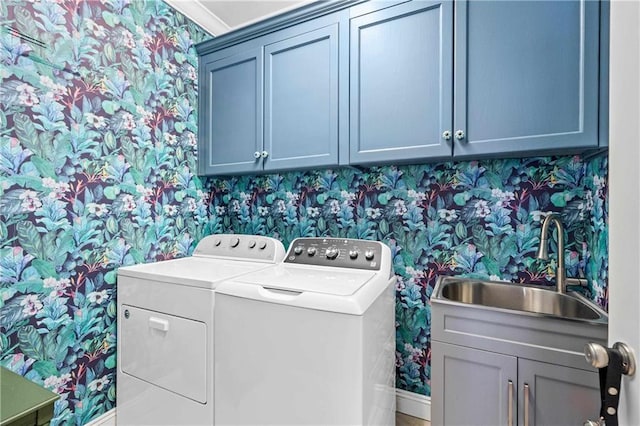 washroom with washing machine and dryer and wallpapered walls