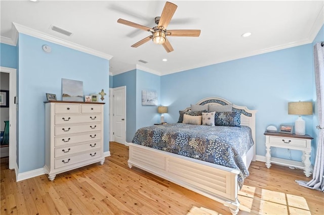 bedroom with light wood-style floors, baseboards, ornamental molding, and visible vents
