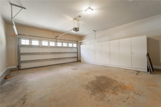 garage with a garage door opener and baseboards