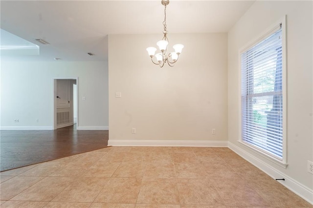 unfurnished room with light tile patterned floors, an inviting chandelier, visible vents, and baseboards