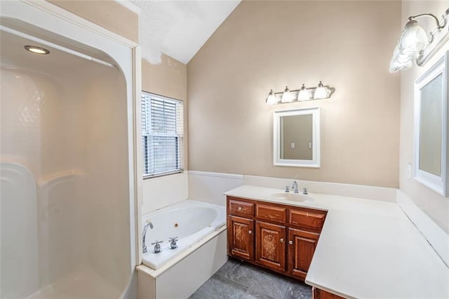 bathroom with lofted ceiling, a stall shower, a tub with jets, and vanity