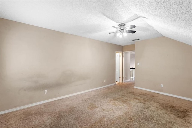 additional living space featuring a textured ceiling, ceiling fan, carpet flooring, visible vents, and baseboards