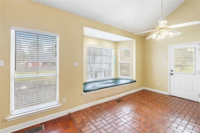 entrance foyer featuring vaulted ceiling, a ceiling fan, visible vents, and baseboards