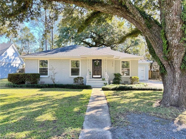 single story home featuring crawl space, an attached garage, a front lawn, and brick siding