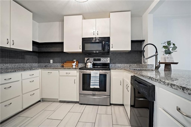 kitchen with stone counters, a sink, white cabinetry, black appliances, and tasteful backsplash