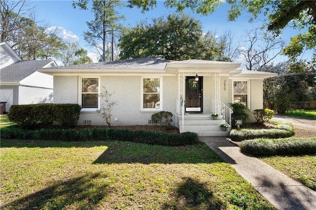 view of front of property featuring crawl space, a front lawn, and brick siding