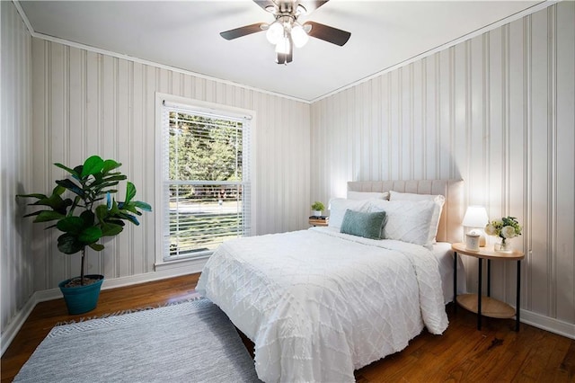 bedroom featuring multiple windows, wood finished floors, and baseboards