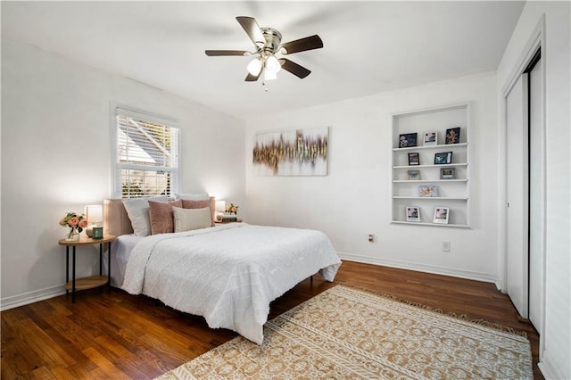 bedroom with a ceiling fan, a closet, baseboards, and wood finished floors