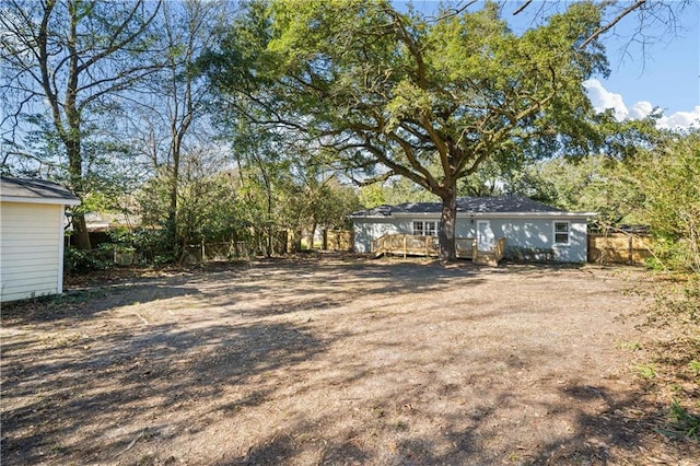 view of yard with fence and a deck