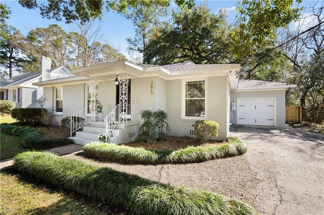 single story home featuring brick siding, an attached garage, crawl space, fence, and driveway