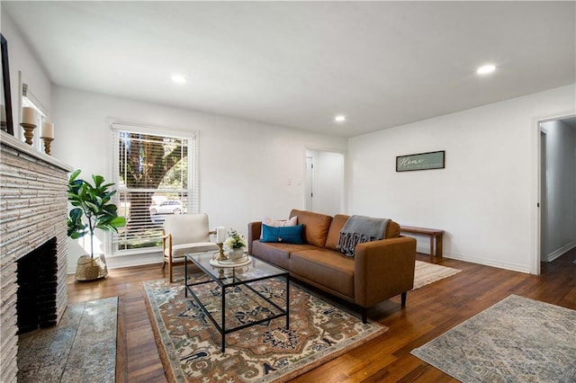 living area with recessed lighting, a fireplace, baseboards, and wood finished floors