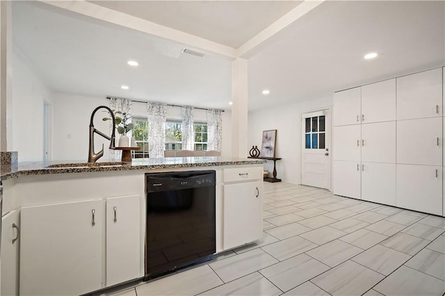 kitchen featuring stone counters, black dishwasher, white cabinets, and a sink