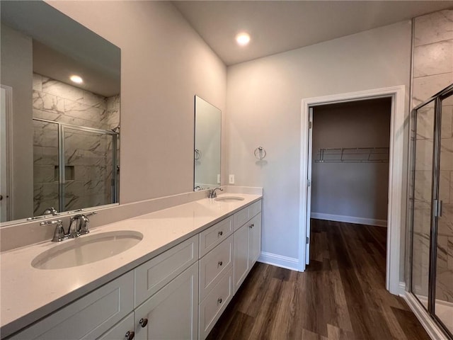 bathroom with vanity, walk in shower, and wood-type flooring