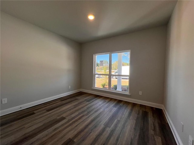 spare room featuring dark hardwood / wood-style floors