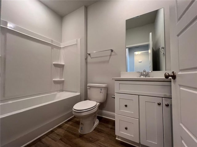 full bathroom featuring toilet, bathtub / shower combination, hardwood / wood-style flooring, and vanity