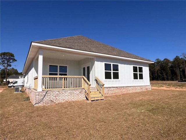 back of property featuring a lawn