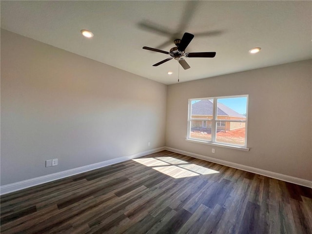 empty room with dark hardwood / wood-style floors and ceiling fan