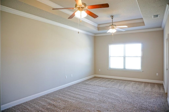 unfurnished room featuring baseboards, visible vents, ornamental molding, a tray ceiling, and carpet floors