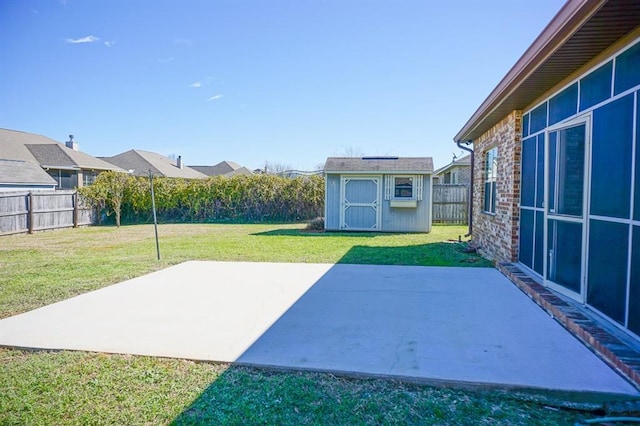 view of patio featuring a storage shed, an outdoor structure, and a fenced backyard