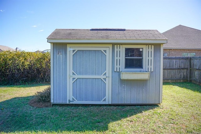 view of shed with fence