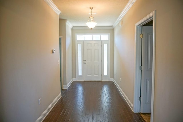 foyer entrance featuring baseboards, dark wood finished floors, and crown molding