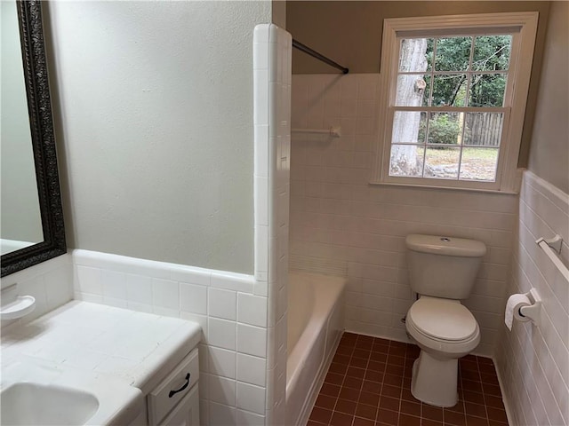 full bathroom with tile walls, tile patterned flooring, toilet, and vanity