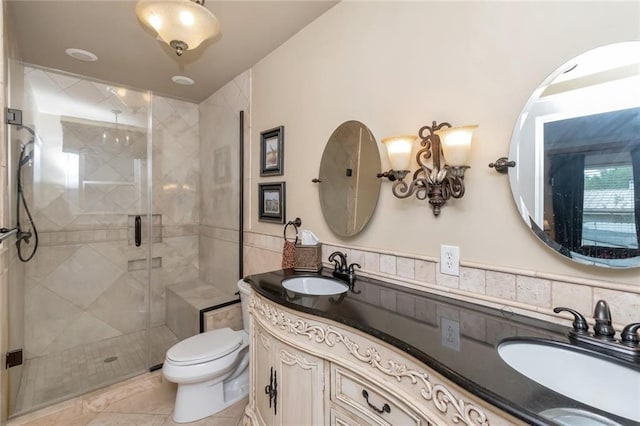 bathroom with tile patterned flooring, a shower with door, toilet, decorative backsplash, and vanity