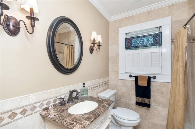 bathroom featuring tile walls, toilet, ornamental molding, and vanity