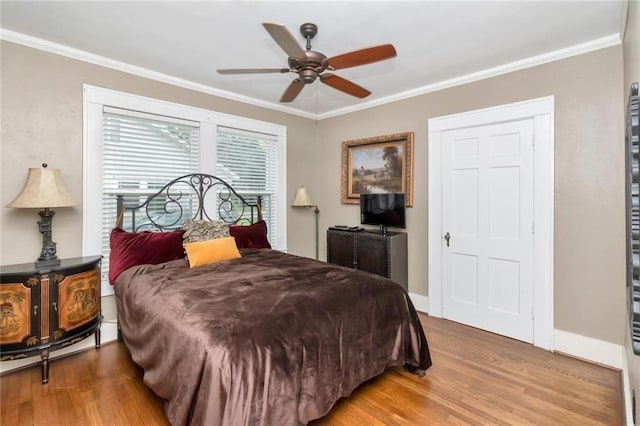 bedroom with ceiling fan, ornamental molding, and hardwood / wood-style floors