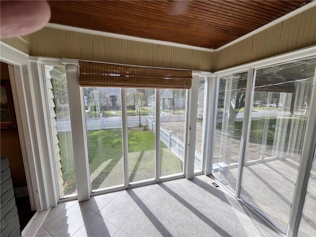 unfurnished sunroom with wooden ceiling and plenty of natural light