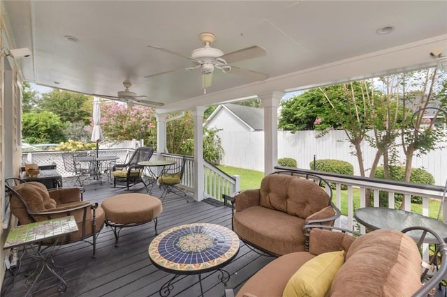 sunroom / solarium featuring a wealth of natural light and ceiling fan