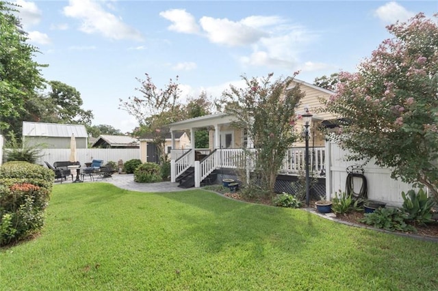 back of property with a lawn and a patio