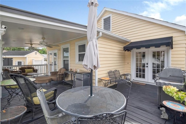 wooden terrace featuring ceiling fan, grilling area, a storage unit, and french doors