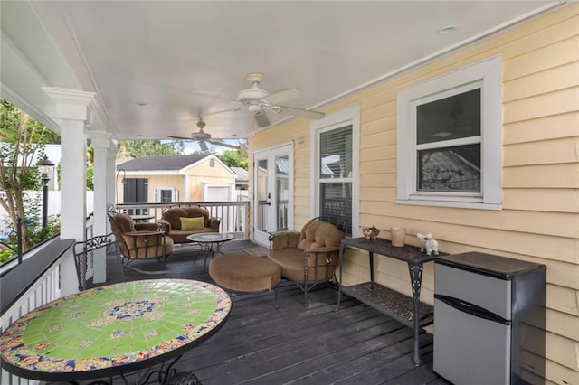 wooden terrace featuring ceiling fan