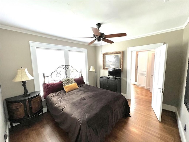 bedroom featuring hardwood / wood-style floors, ceiling fan, and crown molding