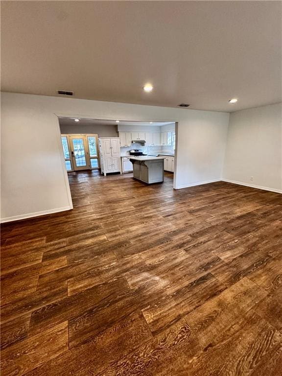 unfurnished living room with dark hardwood / wood-style floors