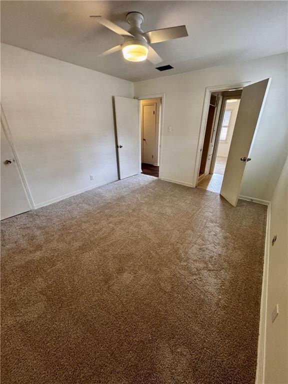 unfurnished room with ceiling fan and carpet flooring