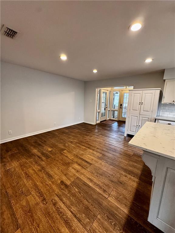 unfurnished living room featuring dark wood-type flooring