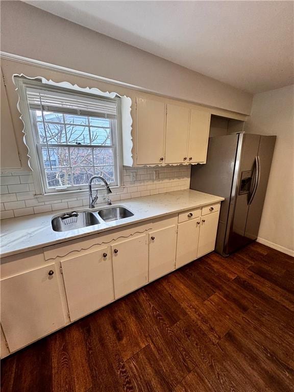 kitchen featuring tasteful backsplash, sink, white cabinets, stainless steel refrigerator with ice dispenser, and dark wood-type flooring