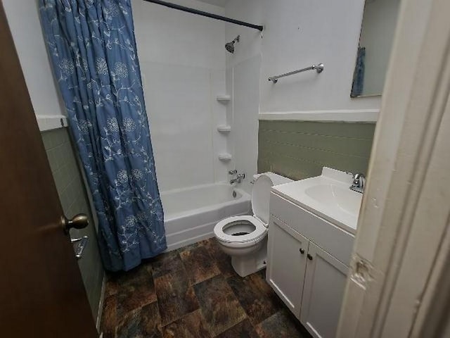 5320 Catherine Dr, Satsuma, AL 36572 - bathroom featuring shower / bath combination with curtain, toilet, vanity, a wainscoted wall, and stone finish flooring