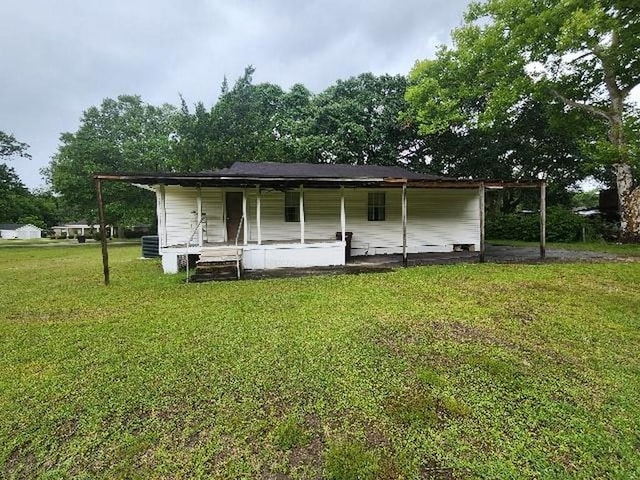 5320 Catherine Dr, Satsuma, AL 36572 - back of property with covered porch, a yard, a carport, and cooling unit