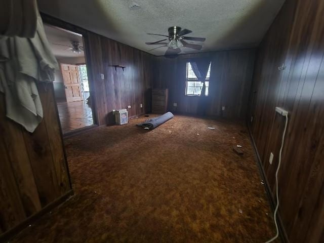 5320 Catherine Dr, Satsuma, AL 36572 - unfurnished bedroom featuring a textured ceiling, carpet flooring, and wood walls