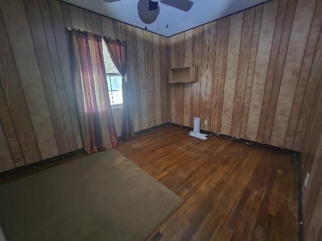 5320 Catherine Dr, Satsuma, AL 36572 - unfurnished room featuring ceiling fan, dark wood-type flooring, and wood walls