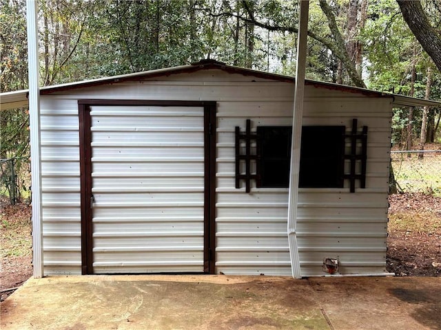 view of shed featuring fence