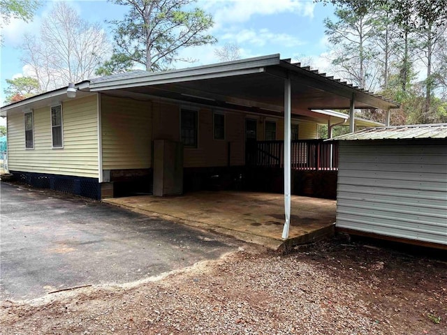 exterior space with a carport and driveway