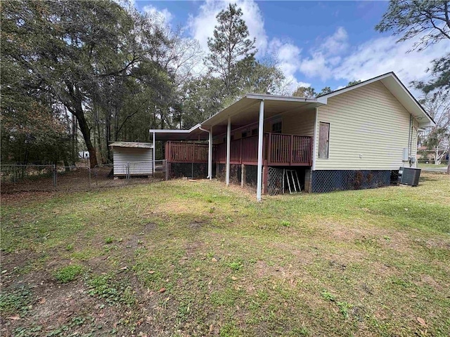 view of side of home featuring cooling unit, a lawn, and fence